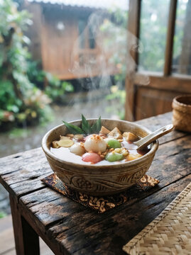 Traditional Indonesian Ginger Soup with Rice Balls on Rustic Table