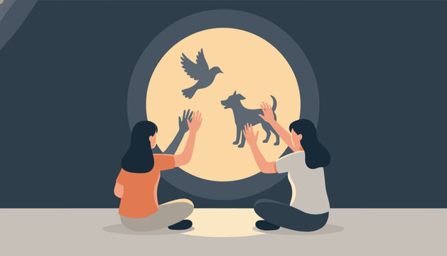 Two girls sitting on the floor making bird and dog shadow puppets on a circular screen using their hands and a light source.