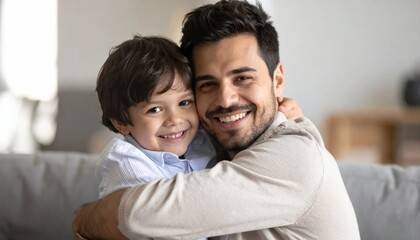 Fototapeta premium Smiling father hugging young son warmly.