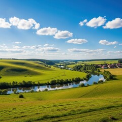 Obraz premium Rolling Green Hills and River Valley Under Blue Sky.