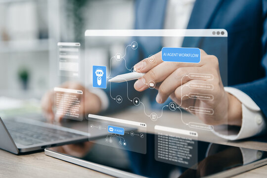 Businessman using a pen and tablet to create AI agent workflows.