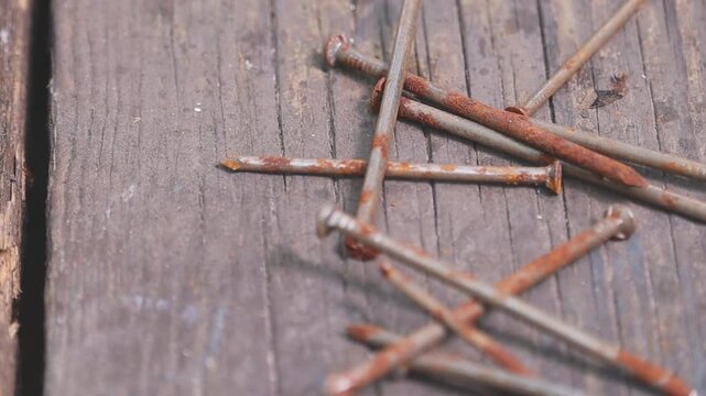 Rusty nails on weathered wood.