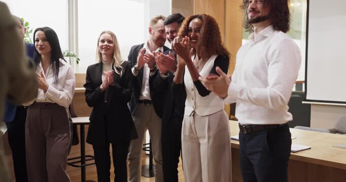 Team colleagues business people highfive applause success. Professionals clap in office as a teammate is recognized capturing teamwork and achievement. Corporate team success celebration concept.