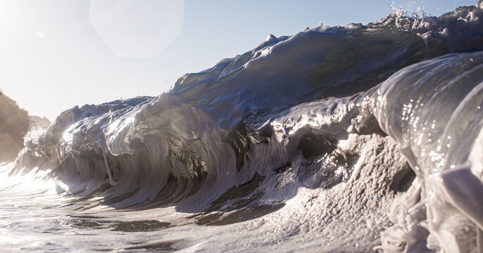 Close Up Texture Of Sea Foam And Clear Blue Water On Sandy Beach