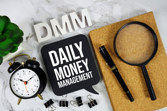 DMM - Daily Money Management acronym with alarm clock and magnifying glass, business concept background