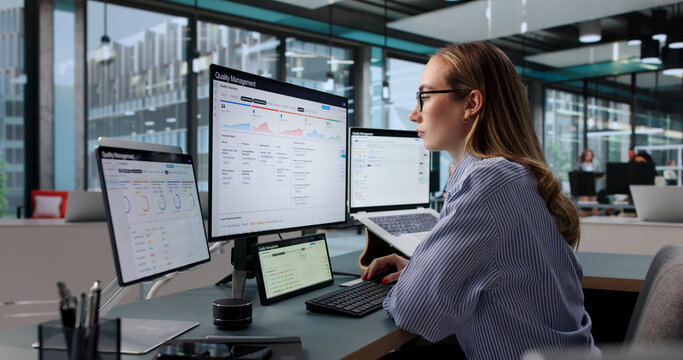 Young Woman Quality Manager Analyzes Corrective Actions Using Laptop