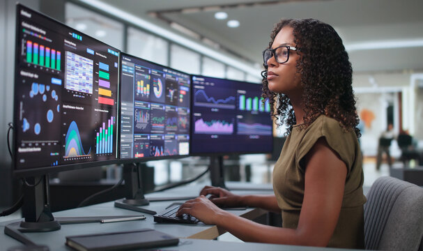 Young African Woman Using Real-time Dashboard