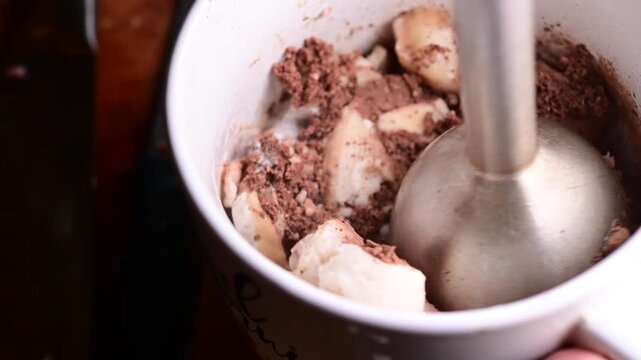 blending banana with coco and butter home made ice cream, close up macro video, background home made ice cream 