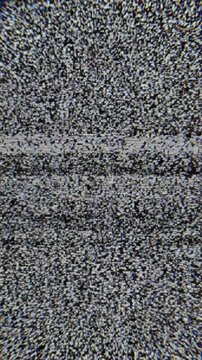 TV static white noise analog glitch interference pattern on black and white screen, vertical video footage.
