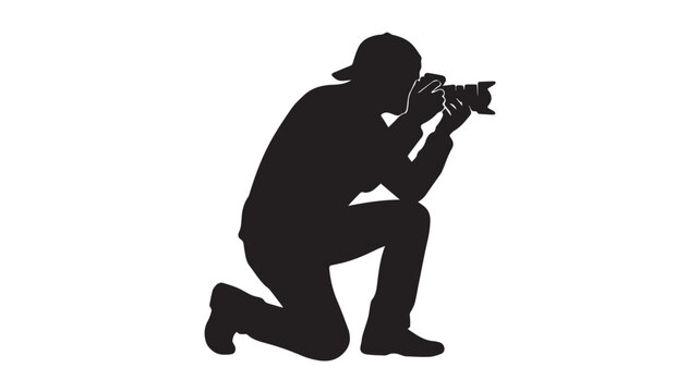 Silhouette of a photographer kneeling with a camera
