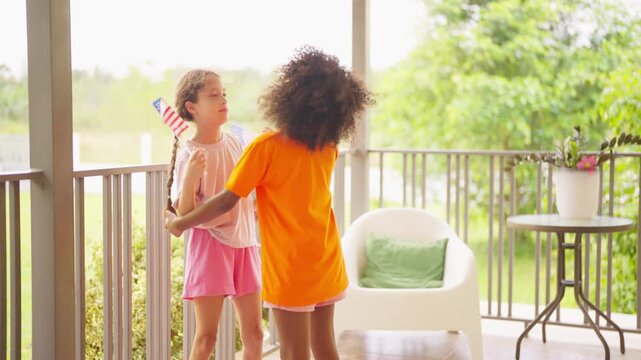 Fourth of July celebration with diverse children girl holding American flags for United States Independence Day expressing patriotism freedom national pride unity community spirit holiday happiness