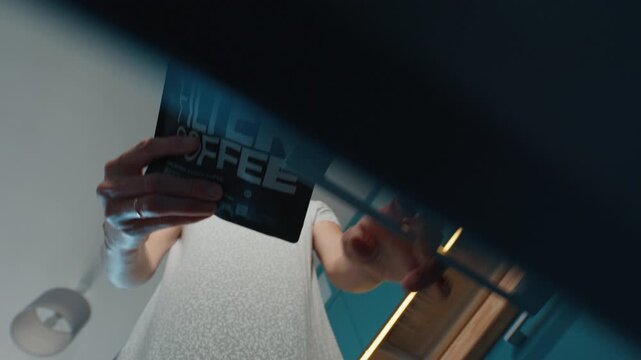Woman opens the shelf and takes out the bag with coffee