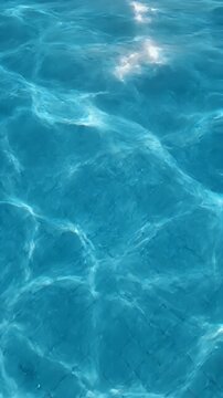 Gentle blue water ripples with sunlit highlights shimmering on surface