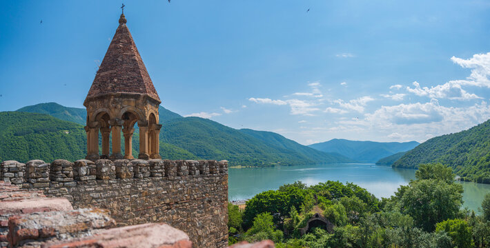 Ancient Ananuri fortress tower with scenic turquoise lake view and text copy space