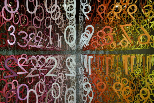Colorful numbers hang in a modern art installation.