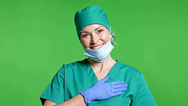Portrait Of A Confident White Female Surgeon In Green Surgical Scrubs Against Bright Green Screen Background