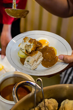 Indonesian siomay dumplings with peanut sauce being served on plate