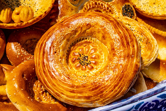 Close up of traditional Central Asian round flatbread with spiral pattern