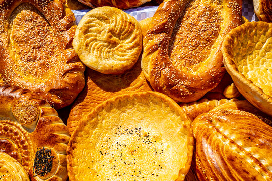 Traditional Central Asian round flatbread piled at market stall