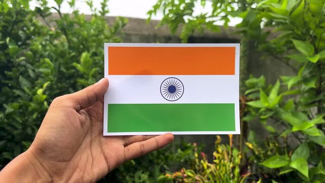Indian national flag held by hand, tricolor flag of India with saffron white and green stripes, patriotic symbol for Independence Day and Republic Day