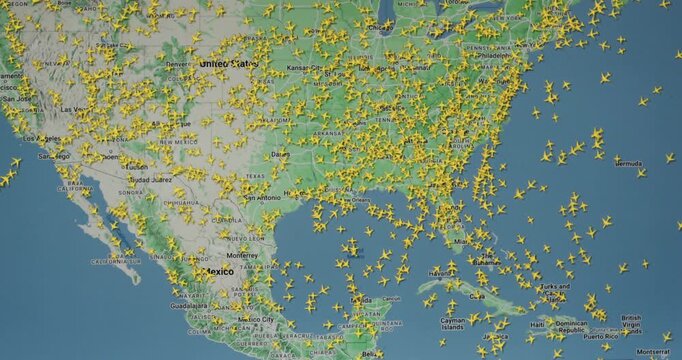 Time lapse of busy air traffic over map on digital screen.
