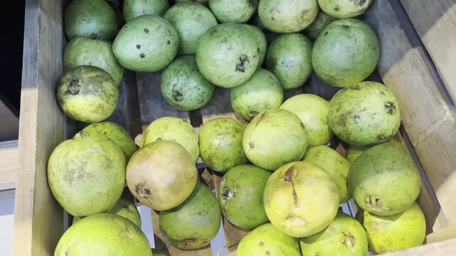 Fresh organic water apples rose apples displayed on wooden box at traditional market