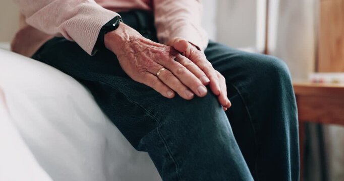 Hands, injury and old man in home with knee pain, medical problem and massage for arthritis symptoms. Senior person, legs and hurt in retirement with osteoporosis, joint inflammation or fibromyalgia.