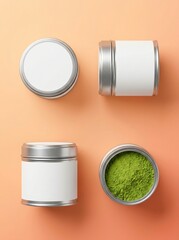 Obraz premium Four metal containers with white labels and green powder