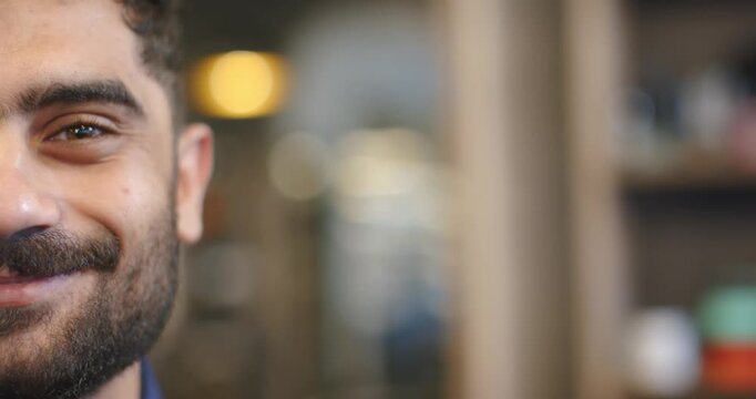 African American man responding to camera, smiling and shifting gaze in office shelves, copy space