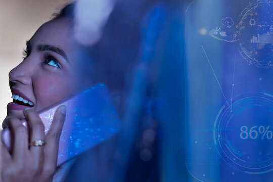Businesswoman talking on smart phone with icons on virtual screen