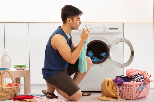 Portrait of young man doing laundry