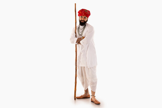 Portrait of Rajasthani man standing against white background