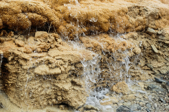 Flowing mineral spring over travertine formations