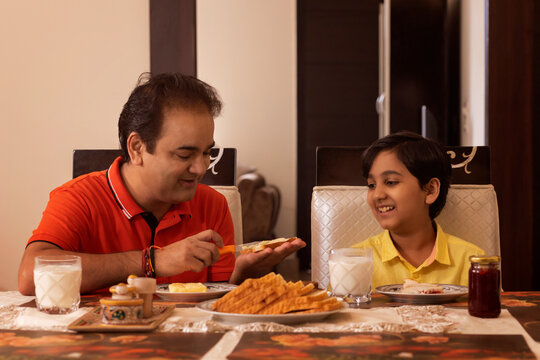 Father and son having their breakfast at home