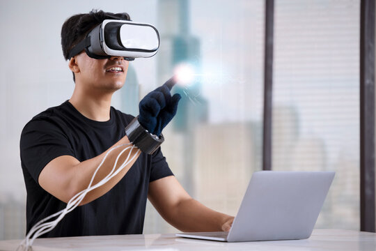 Man wearing VR headset and haptic glove interacting with virtual object/person in the metaverse