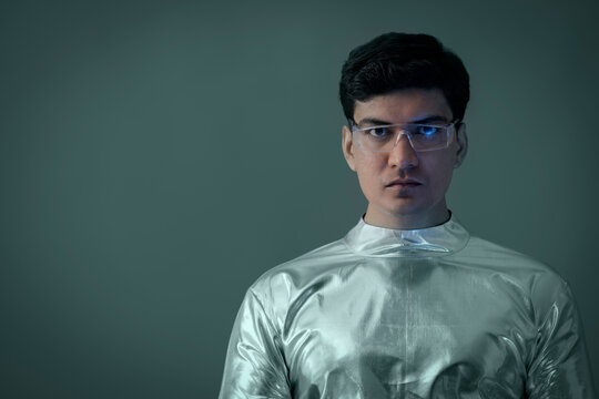 A man wearing silver,futuristic clothes wearing glasses, future technology concept