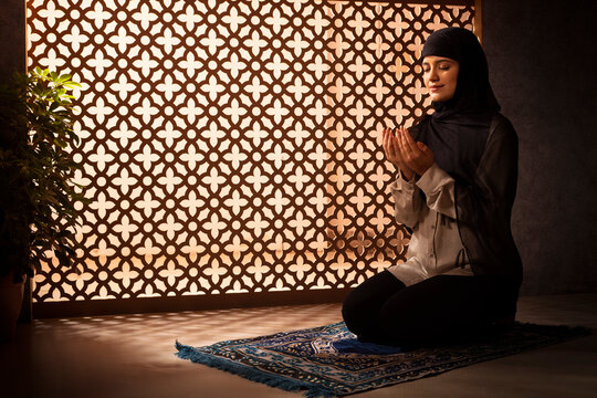 Portrait of a Muslim woman praying at home