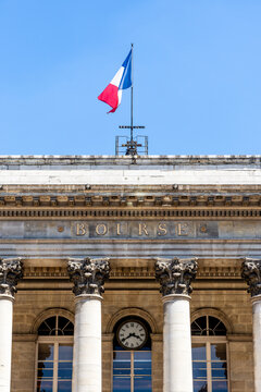 Paris, France - June 17, 2026: Close-up on the "Bourse" (Stock exchange) inscription in gilded letters on the 1826 Palais Brongniart, formerly Palais de la Bourse, with the French flag flying above.