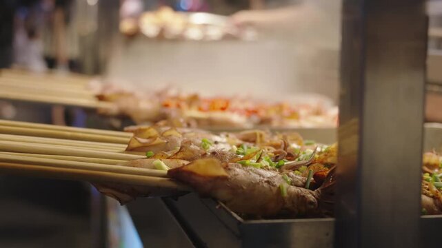 Cooking squid on grill in Chinese street-food restaurant in market, seafood. Closeup view, healthy dietetic nutrition, street food in Asian city, gastronomy travel in china, enjoy traditional cuisine