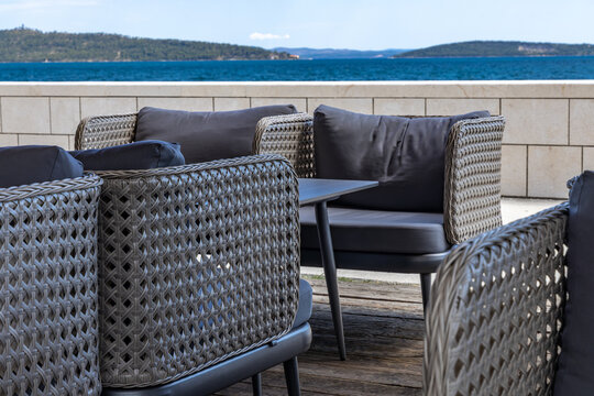 Empty chairs at a seaside restaurant overlooking the crystal-clear Adriatic Sea near Split, Croatia. 