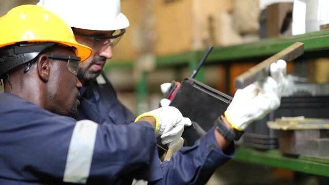 Industrial worker slowly examines finished machined part before production approval. Slow motion quality inspection inside modern factory with precision engineering workflow.