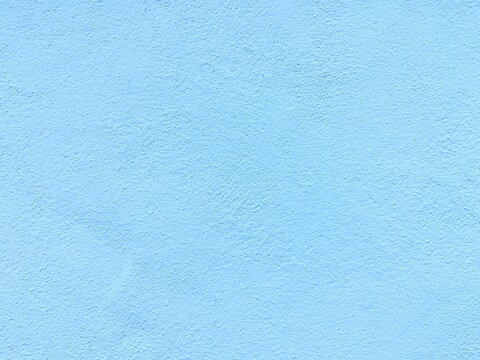 Light blue wall texture background, pastel blue concrete surface, solid color backdrop for design