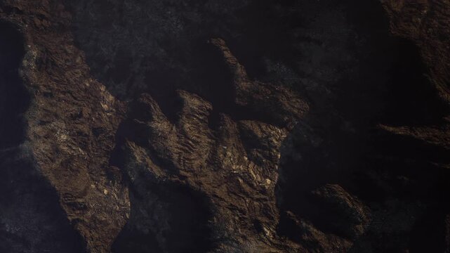 The scene shows a detailed view of a rocky surface with deep textures and shadows. The lighting suggests it is likely evening or morning in a natural setting.