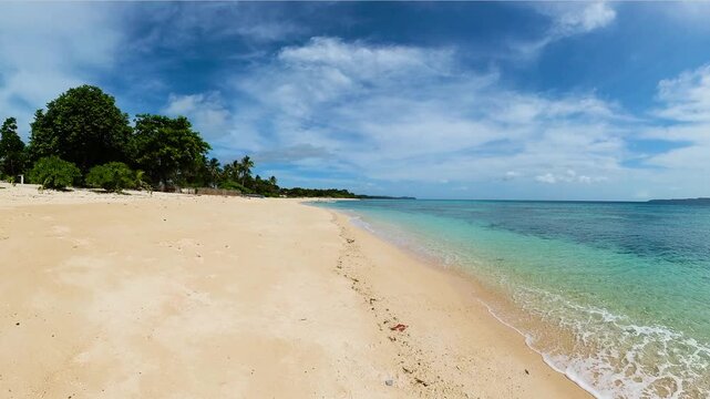 Ocean waves crashing each other over the sands. Santa Fe, Tablas Island. Romblon, Philippines.