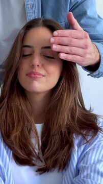 A man surprises his loving girlfriend with a special gift, covering her eyes to build anticipation. Her joyous reaction upon seeing the present highlights the beautiful moment of love, happiness, and 