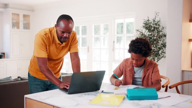 Education, remote work and son with father in home for business, child development or learning. Computer, notebook and study with African family at apartment counter for freelance job or school