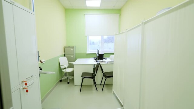 Examination room includes desks and examination couch for patient assessments. Professional environment designed for medical evaluations