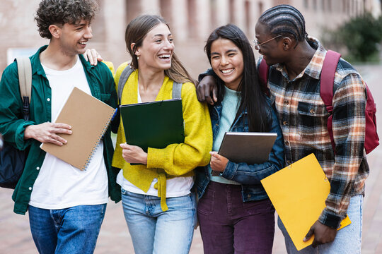 Happy University students having fun together laughing after exams and classes