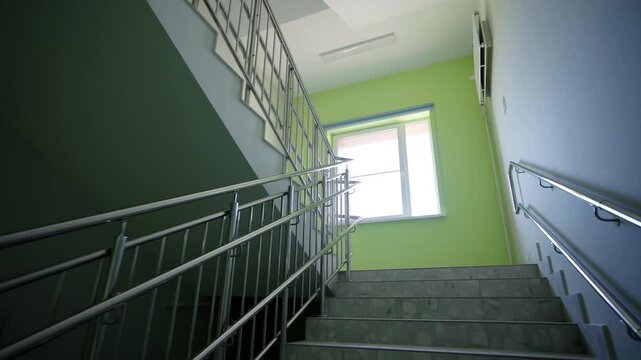 Hospital stairs rise from hallway to upper floors. Staircase creates clean and well-organized passageway for patients and medical staff