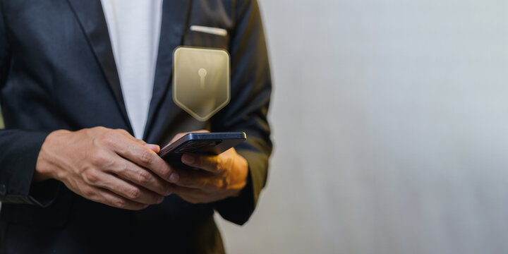 Business professional using smartphone with smartphone holder badge and background wall